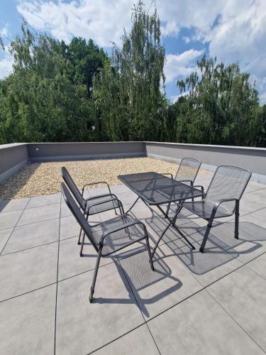 two chairs and a table on a patio at Moderný Loft s Terasou v centre mesta Prievidza in Prievidza