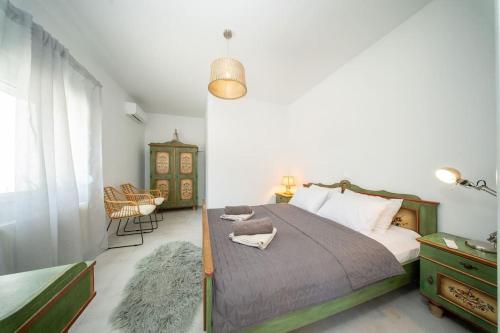 a bedroom with a bed and a table and chairs at Villa Aionia in Lepeda in Lixouri