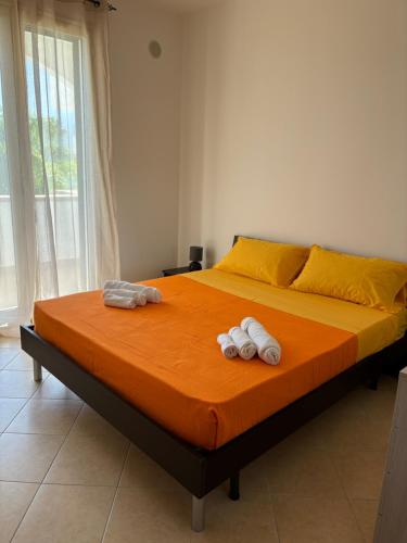 a bedroom with a bed with two towels on it at Daniel's in Isola delle Femmine