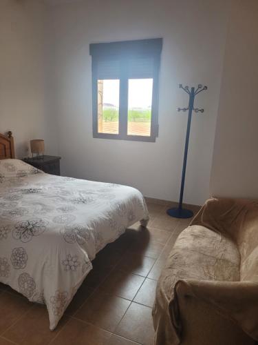 a room with two beds and a cross on the wall at Casa Rural en Casasimarro in Casasimarro