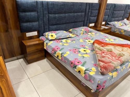 a bedroom with a bed with hello kitty sheets and pillows at Divya Hotel in Rishīkesh