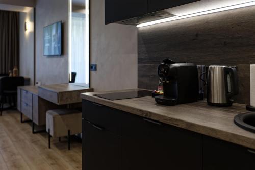 a kitchen with a counter with a coffee maker on it at Glacier Premium Apartments in Bukovel