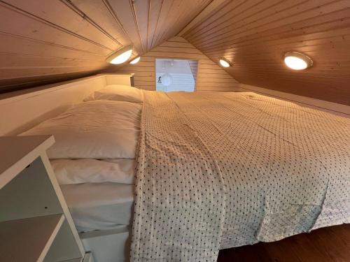 a bedroom with a bed in a small room at Gästhuset Nagu Paradiset in Nauvo