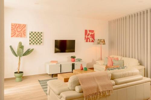 a living room with a couch and a table at Glam House no coração da cidade in Faro