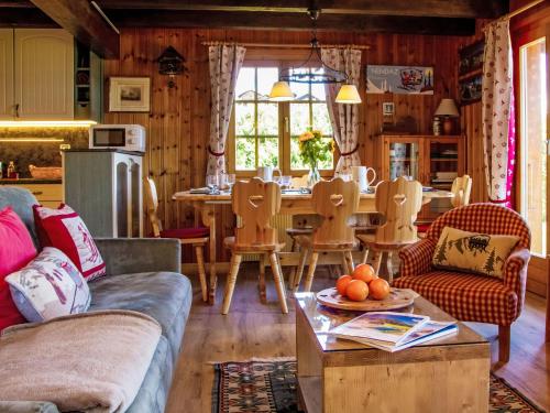 uma sala de estar com um sofá e uma mesa em Chalet Mirabeau 8 by Interhome em Nendaz