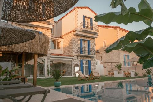 a villa with a swimming pool in front of it at Alacati Fora Bella in Alacati