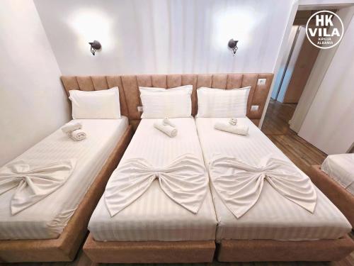 a bedroom with two beds with bows on them at Vila HK in Krujë
