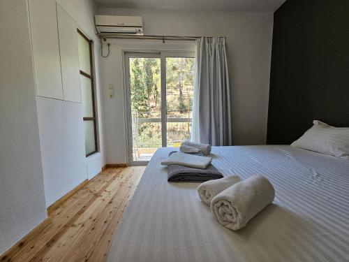 a bedroom with a bed with towels on it at Lycabettus Urban Elegance by YHA in Athens