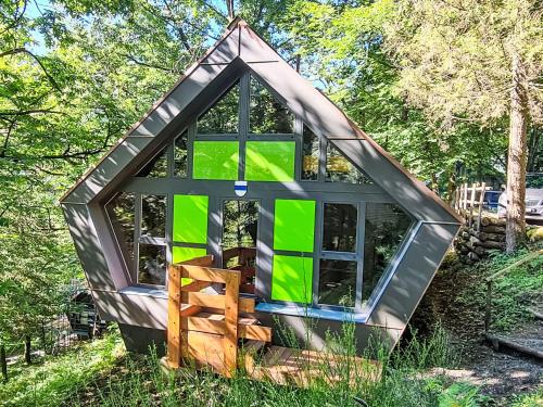 a tiny house in the middle of the grass at Chalet Bosco della Bella 6 by Interhome in Termine