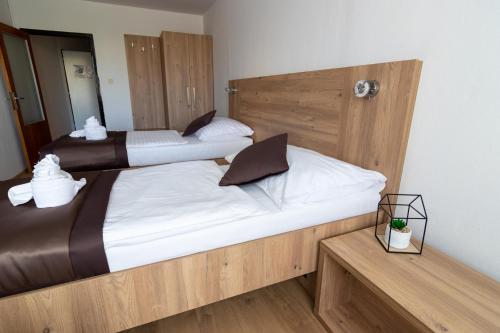 two twin beds in a room with a mirror at Hotel Akadémia in Košice