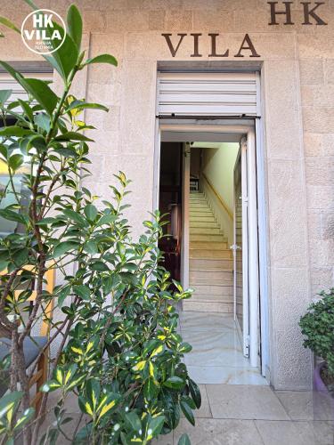 a building with a stairway leading to a door at Vila HK in Krujë