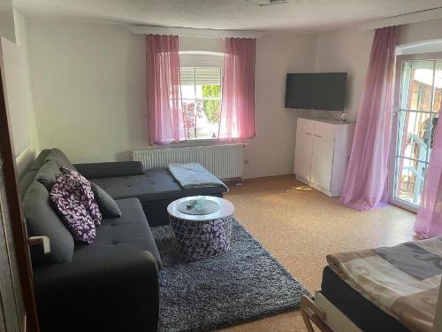 a living room with a couch and a tv at Ferienwohnung Eifler in Lam