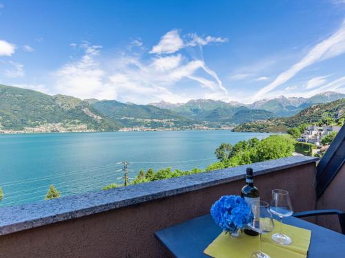 a table with wine glasses and a view of a lake at Apartment Vento Errante by Interhome in Dorio