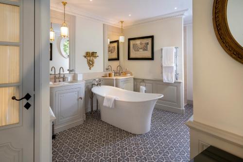 a white bathroom with a tub and a sink at Villa Saint-Ange in Aix-en-Provence