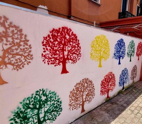 a wall with trees painted on it at Camelia Rooms Venice Guesthouse in Mestre