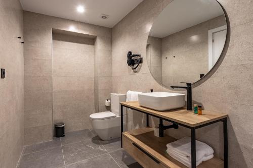a bathroom with a sink and a mirror at Arenal Suites Bilbao in Bilbao