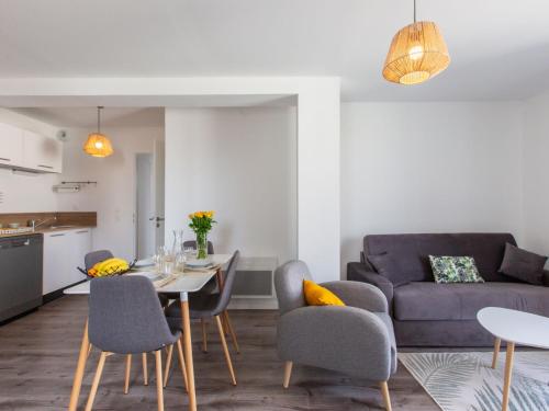 ein Wohnzimmer mit Tisch und Couch in der Unterkunft Apartment Cap Océan-11 by Interhome in Capbreton