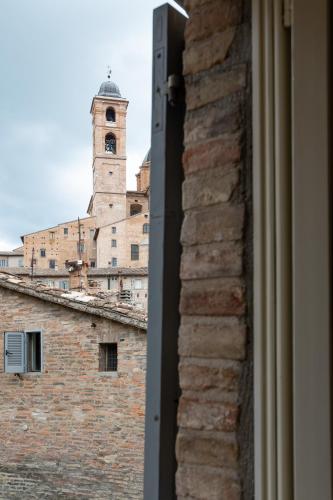 a view of a building with a clock tower from a window at Urbino Apartment - Urban Retreat in Urbino