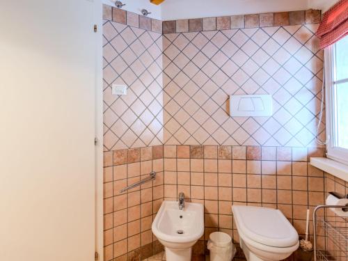 a bathroom with a toilet and a sink at Apartment Carli by Interhome in Campo Lomaso