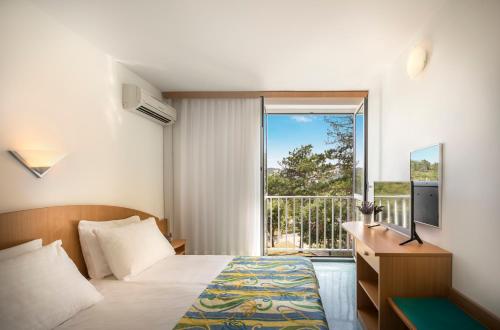 Postel nebo postele na pokoji v ubytování San Marino Resort