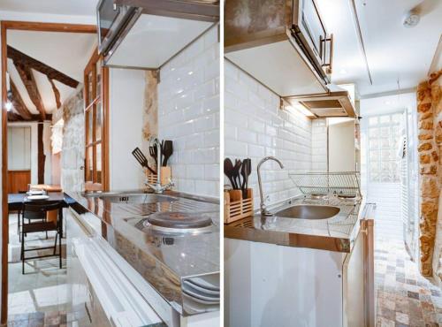 une cuisine avec un évier et un plan de travail dans l'établissement Charming Apt Rue st André des arts, à Paris