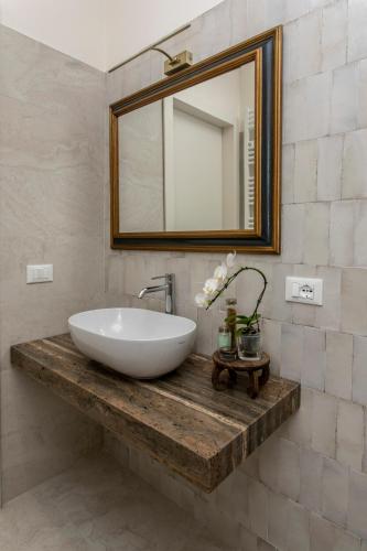 a bathroom with a white sink and a mirror at Villa Tuzzo in Lecce