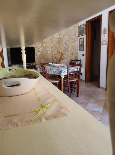 a kitchen with a table with a bowl on the counter at L'Azzurro Apartment in Valderice