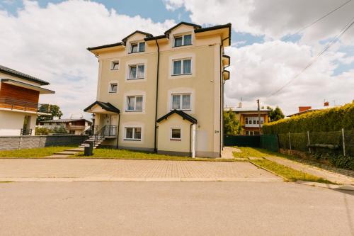 a large white building on the side of a street at Apartamenty Krzywa in Krosno