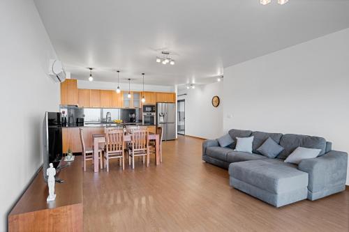 a living room and kitchen with a couch and a table at Calheta Paradise Holiday Home - Free Parking & Views in Arco da Calheta