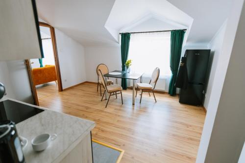 a kitchen and dining room with a table and chairs at Apartamenty Krzywa in Krosno