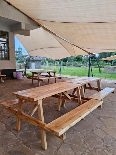 a group of picnic tables with an umbrella at Jsons executive suites in Nairobi