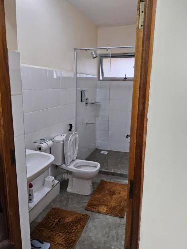 a bathroom with a toilet and a sink at Jsons executive suites in Nairobi