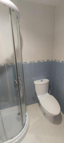 a bathroom with a toilet and a glass shower at Cala Blanca on the beach in El Borseral