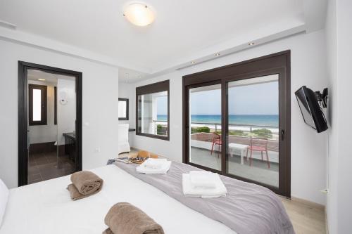 a bedroom with a bed with a view of the ocean at Villa Dionysos in Lachania