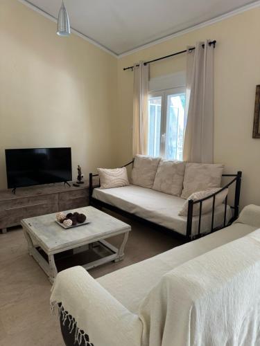 a living room with a couch and a table at Dolphin in Kavala