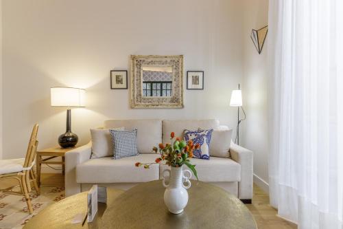 a living room with a couch and a table at Palacio Vegafuente by Caleta Homes in Málaga