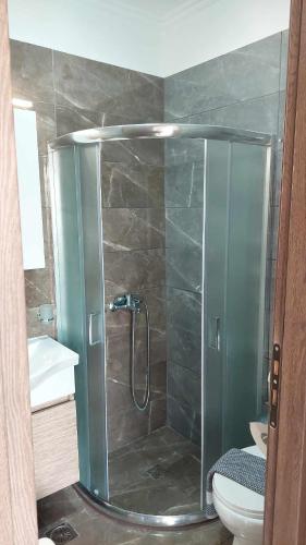 a shower with a glass door in a bathroom at Sea La Vie Beach House in Petra