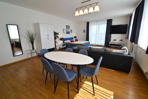 a living room with a table and chairs and a couch at Am Schloss 108 in Schwerin
