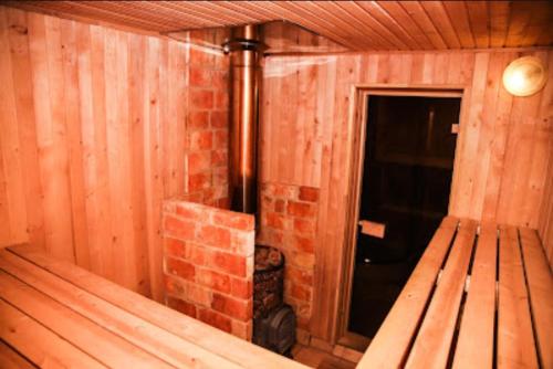 an empty room with a brick fireplace and a bench at Pastoral wooden hauses in Velikiy Les