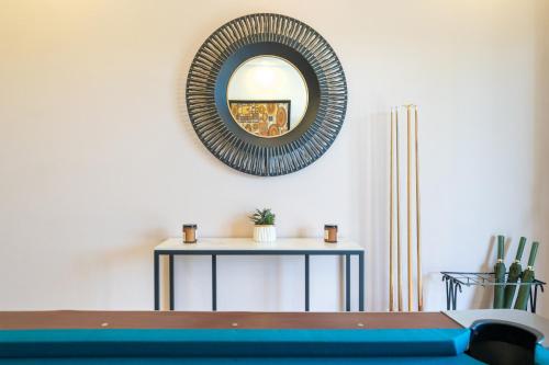 a mirror on the wall above a table at Golden Sands Villa only 15 minutes walk to beach in Ban Lum Fuang
