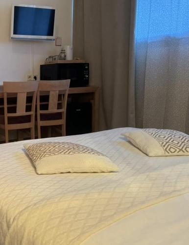 a bedroom with a bed with two pillows on it at Ma Campagne in Saint-Rémy