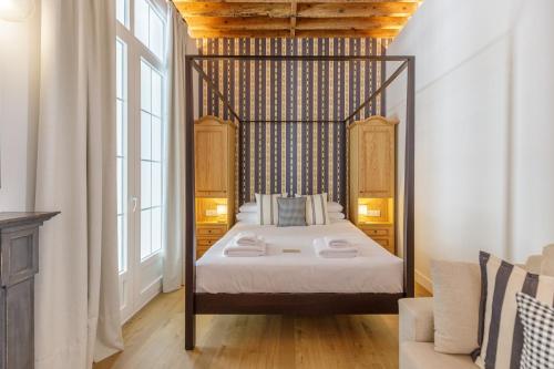 a bedroom with a canopy bed in a room at Palacio Vegafuente by Caleta Homes in Málaga