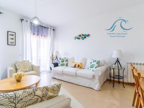 a living room with a white couch and a table at Fabulous Apartment Nazaré in Nazaré