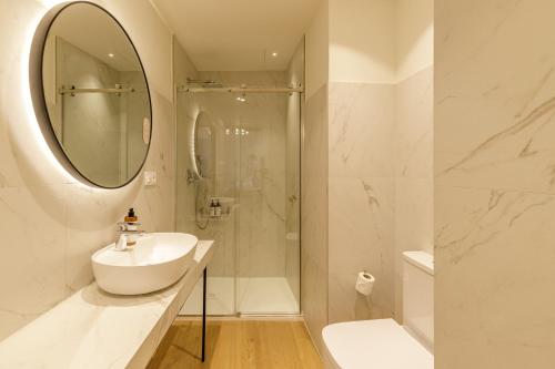 a white bathroom with a sink and a shower at Palacio Vegafuente by Caleta Homes in Málaga