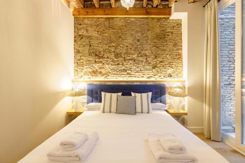 a bedroom with a bed with two towels on it at Palacio Vegafuente by Caleta Homes in Málaga