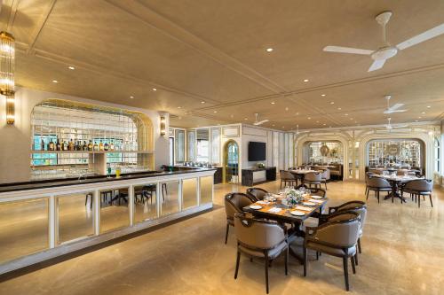 a restaurant with tables and chairs and a bar at Fortune Valley View, Manipal - Member ITC Hotels' Group in Manipala