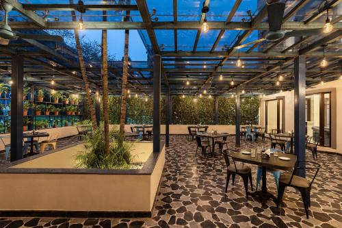 an outdoor patio with tables and chairs and lights at Fortune Valley View, Manipal - Member ITC Hotels' Group in Manipala
