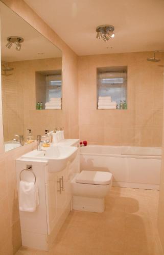 a bathroom with a sink and a toilet and a tub at Valley View in Harrogate
