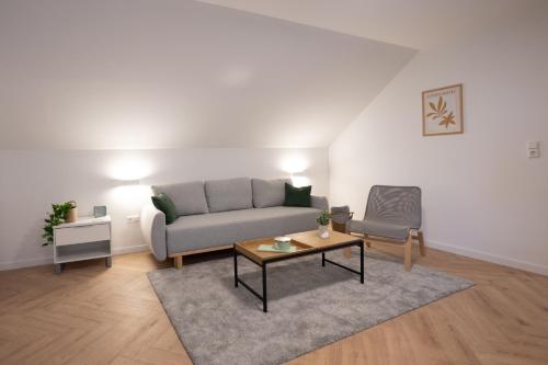 a living room with a couch and a table at Lux Loft Spa in Rakovica