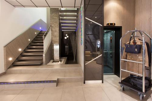 a lobby with a staircase in a building at Hôtel Point France in Arcachon